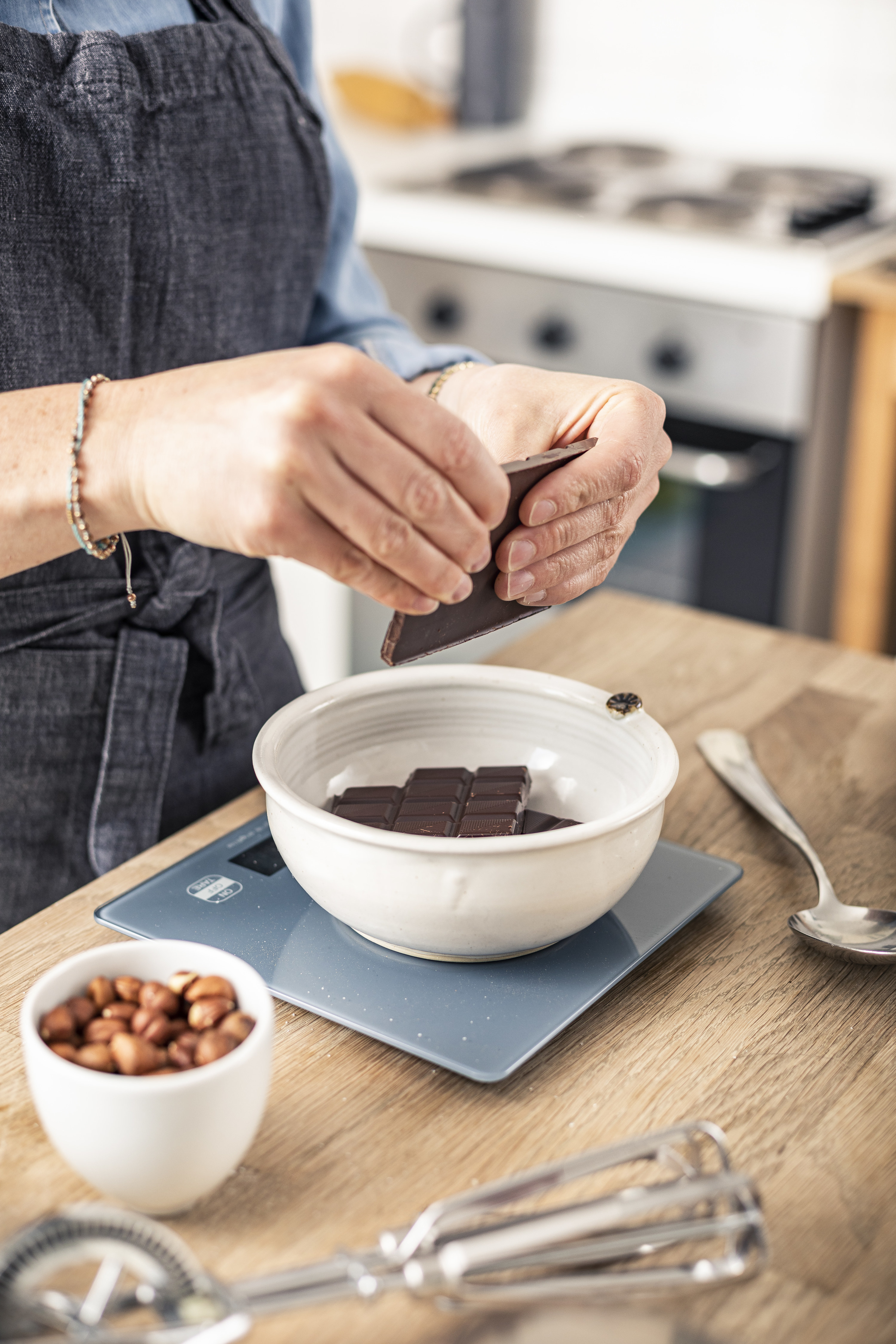 Woman measuring chocolate for a recipe